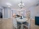 Dining area showcasing a chandelier, round table, and view into the open living area at 112 Sevilla Ct, Poinciana, FL 34759