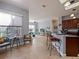 View of an open-concept kitchen and living space with bar stool seating and natural light at 112 Sevilla Ct, Poinciana, FL 34759