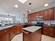 Kitchen featuring an island, stainless steel appliances, and warm wood cabinetry at 112 Sevilla Ct, Poinciana, FL 34759