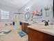 Bright main bathroom featuring double sinks, a soaking tub, and a glass-enclosed shower at 112 Sevilla Ct, Poinciana, FL 34759