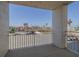 Balcony overlooking the street, palm trees, and buildings on a bright, sunny day at 2071 S Atlantic Ave # 201, Daytona Beach Shores, FL 32118