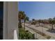 Beach view from the balcony, highlighting the sand and palm trees at 2071 S Atlantic Ave # 201, Daytona Beach Shores, FL 32118