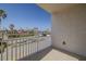 Balcony view of the street, palm trees, and businesses nearby on a bright, sunny day at 2071 S Atlantic Ave # 201, Daytona Beach Shores, FL 32118