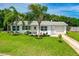 White single story home with palm trees and grassy yard at 45 San Jose Dr, Ormond Beach, FL 32176