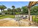 Wooden deck with gazebo, lounge chairs, and a view of tropical foliage at 45 San Jose Dr, Ormond Beach, FL 32176