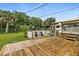 Deck with hot tub, pergola, lounge chairs, and grassy yard at 45 San Jose Dr, Ormond Beach, FL 32176