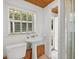 Bathroom with pedestal sink and exterior access at 45 San Jose Dr, Ormond Beach, FL 32176