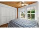 Bright bedroom with wood ceiling, striped bedding, and view of backyard at 45 San Jose Dr, Ormond Beach, FL 32176