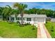 Charming single-story home with lush landscaping, palm trees, and a well-maintained green lawn at 45 San Jose Dr, Ormond Beach, FL 32176
