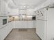 Bright eat-in kitchen with white cabinetry and tile floors at 45 San Jose Dr, Ormond Beach, FL 32176
