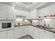 White kitchen with stainless steel sink and appliances at 45 San Jose Dr, Ormond Beach, FL 32176