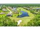 Beautiful aerial shot of a golf course community featuring luxury homes surrounding a scenic lake at 1128 Kilkenny Ln, Ormond Beach, FL 32174