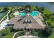 Stunning aerial view of the community clubhouse with pools, surrounded by lush greenery at 1128 Kilkenny Ln, Ormond Beach, FL 32174