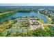Scenic aerial shot showcasing community tennis courts, clubhouse, pools and a tranquil lake at 1128 Kilkenny Ln, Ormond Beach, FL 32174
