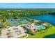 Aerial view featuring tennis courts, a community pool, clubhouse and abundant trees at 1128 Kilkenny Ln, Ormond Beach, FL 32174