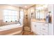 Relaxing bathroom featuring a soaking tub, walk-in shower, and vanity with great lighting at 3 Seabridge Dr, Ormond Beach, FL 32176