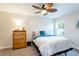 Cozy bedroom features soft carpet, natural light from a window, and a decorative ceiling fan at 3 Seabridge Dr, Ormond Beach, FL 32176