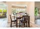 Cozy dining area with views of the pool, seamlessly connecting indoor and outdoor living spaces at 3 Seabridge Dr, Ormond Beach, FL 32176