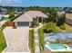 Landscaped home with long driveway, attached garage, and a screened-in pool area at 3 Seabridge Dr, Ormond Beach, FL 32176