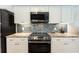 Modern kitchen featuring updated stainless steel appliances, beautiful backsplash, and plenty of counterspace at 3 Seabridge Dr, Ormond Beach, FL 32176