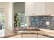 Modern kitchen with granite countertops and stainless steel sink, overlooking pool at 3 Seabridge Dr, Ormond Beach, FL 32176