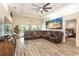 Living room with sectional sofa, large TV, and pool view at 3 Seabridge Dr, Ormond Beach, FL 32176