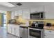 A well-lit kitchen with stainless steel appliances and ample counter space for meal preparation at 1239 Ocean Shore Blvd # 7E5, Ormond Beach, FL 32176