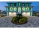 Charming coastal home with lush landscaping, a paver driveway, and an inviting front entrance at 4711 S Atlantic Ave, Ponce Inlet, FL 32127