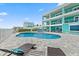 Beautifully landscaped backyard with a sparkling pool and outdoor seating, creating an ideal entertaining space at 4711 S Atlantic Ave, Ponce Inlet, FL 32127