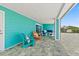 Inviting covered patio with colorful seating, perfect for relaxation and enjoying the outdoor space at 4711 S Atlantic Ave, Ponce Inlet, FL 32127
