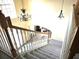 Elegant staircase with chandelier, leading to the home's main level at 2 King Phillips Way, Ormond Beach, FL 32174