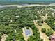 Aerial view of the property showcasing its lush, green surroundings, and private pool at 5701 John Anderson Hwy, Flagler Beach, FL 32136