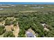 Aerial view of a neighborhood surrounded by mature trees, the ocean, and marshes at 5701 John Anderson Hwy, Flagler Beach, FL 32136