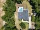 Aerial view of the home surrounded by mature trees and a screened pool at 5701 John Anderson Hwy, Flagler Beach, FL 32136