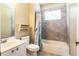 Bathroom with tiled shower and tub combination with a single sink vanity at 5701 John Anderson Hwy, Flagler Beach, FL 32136