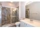 Bathroom featuring a glass-enclosed shower with a tiled surround, vanity, toilet, and large mirror at 5701 John Anderson Hwy, Flagler Beach, FL 32136