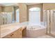Bathroom featuring a large tub, a glass-enclosed shower, and tile flooring at 5701 John Anderson Hwy, Flagler Beach, FL 32136