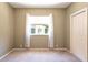 Bright bedroom features neutral walls, carpet and window with white curtains at 5701 John Anderson Hwy, Flagler Beach, FL 32136