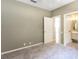 Bedroom with neutral paint, carpet flooring and an en suite bathroom at 5701 John Anderson Hwy, Flagler Beach, FL 32136