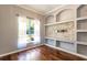 Cozy bedroom with hardwood floors, natural light, and modern built-in shelving and storage at 5701 John Anderson Hwy, Flagler Beach, FL 32136