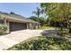 Side view of the house with a large garage and a spacious driveway at 5701 John Anderson Hwy, Flagler Beach, FL 32136