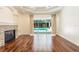 Open living area with wood floors, stone fireplace, and sliding glass doors to the pool area at 5701 John Anderson Hwy, Flagler Beach, FL 32136