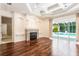 Open-concept living area with fireplace, hardwood floors, pool view, and lots of sunlight at 5701 John Anderson Hwy, Flagler Beach, FL 32136