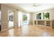 Bright living room features tile floors, a view of the pool, built-in shelves, and lots of sunlight at 5701 John Anderson Hwy, Flagler Beach, FL 32136