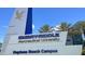 Signage for Embry-Riddle Aeronautical University Daytona Beach Campus, set against a clear blue sky with palm trees at 108 Lacosta Ln # 621, Daytona Beach, FL 32114