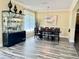 Elegant dining room featuring a modern display case and a large dining table set for a dinner at 28 Dormer Dr, Ormond Beach, FL 32174