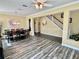 Open dining room with stylish wood floors, chandelier, and a view into the foyer and staircase at 28 Dormer Dr, Ormond Beach, FL 32174