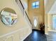 Inviting foyer featuring dark tile flooring, staircase, and decorative mirror adds style and charm at 28 Dormer Dr, Ormond Beach, FL 32174