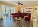 Bright living room with plush red sofa, access to a patio with a pool and a modern kitchen at 28 Dormer Dr, Ormond Beach, FL 32174