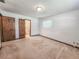 This carpeted bedroom has a view of the bathroom through the open doorway at 1119 Indigo Rd, Ormond Beach, FL 32174